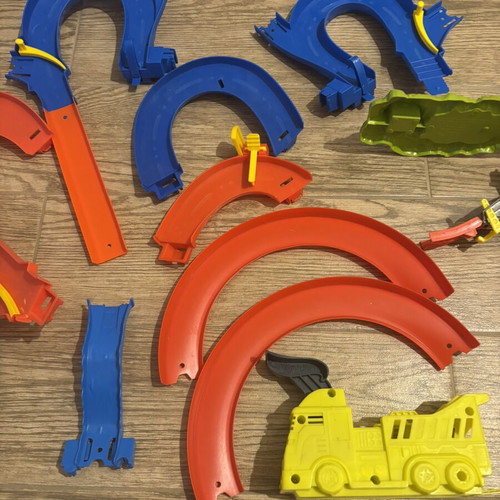 Hot Wheels track set pieces with T-Rex figure and launcher
