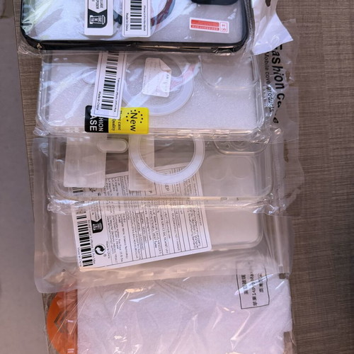 I Phone 14 Pro Max accessories with four cases, two screen protectors, and charging cable