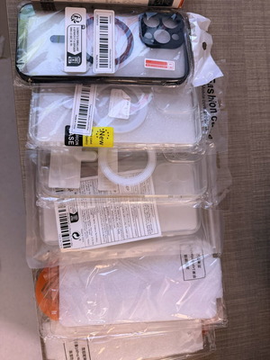I Phone 14 Pro Max accessories with four cases, two screen protectors, and charging cable