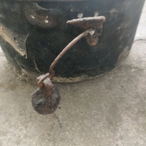 Large handmade bronze cauldron used with iron handles