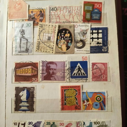 Stamp album like new with about 500 mostly foreign stamps