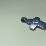 Silver cross used with stone