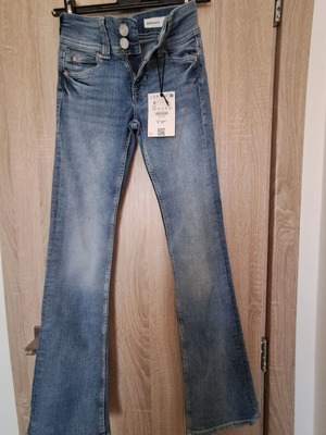 Bershka flared jeans new, faded blue with buttoned back pockets