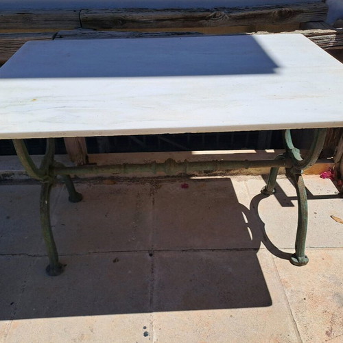 Table with cast iron base and marble used