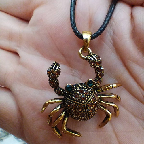 Crab pendant like new, dark gold with stones