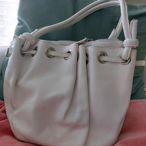 White bucket handbag used with decorative buttons