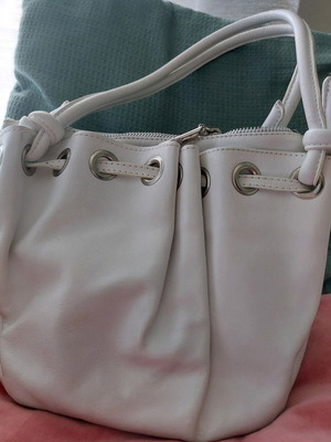 White bucket handbag used with decorative buttons