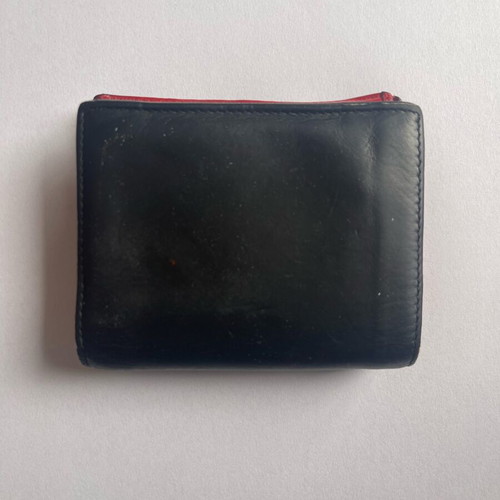 Christian Louboutin wallet used with missing spike and black stains