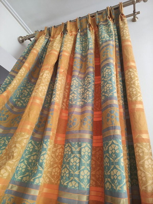 Curtain set used with embossed jacquard pattern in orange, gold, petrol