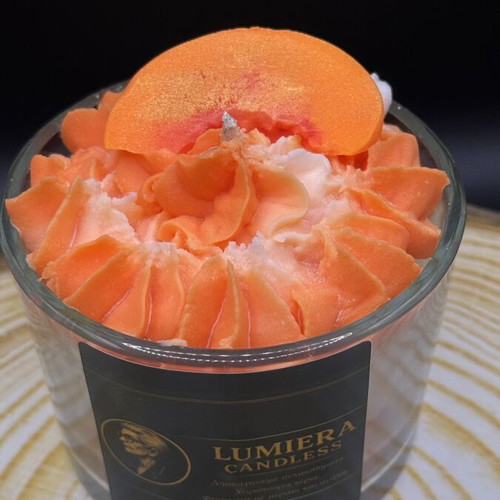 Handmade soy candle in glass container with peach scent