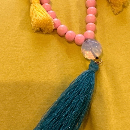 Long necklace with pink stones and evil eyes used, yellow and petrol tassels