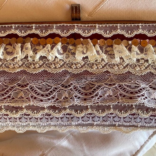Evening hand bag like new with romantic lace decoration and copper tone