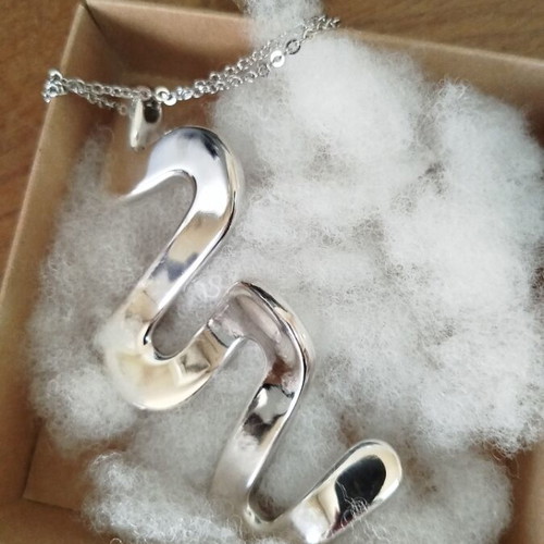 Silver necklace with wave-shaped snake pendant like new