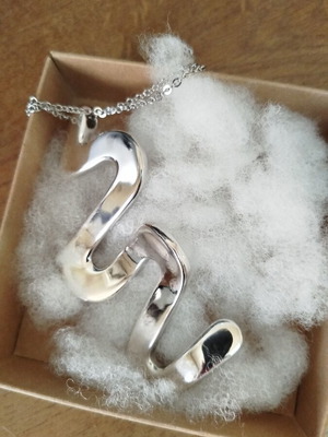 Silver necklace with wave-shaped snake pendant like new