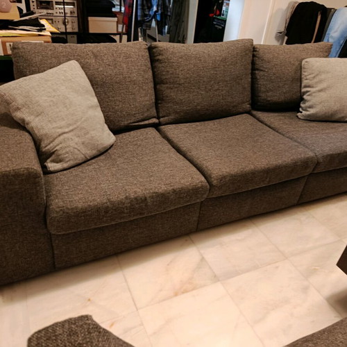 Three-seater sofa used in gray color with two cushions