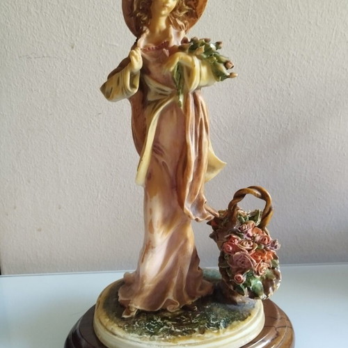 Vintage Italian decorative statue of a girl with roses, used