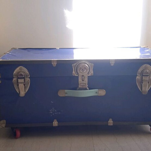 Vintage trunk table refurbished with leather handle and wheels