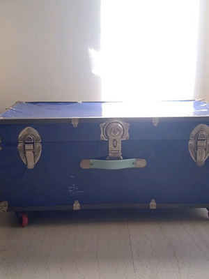 Vintage trunk table refurbished with leather handle and wheels