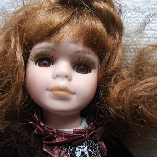 Porcelain doll used with base, box and accessories