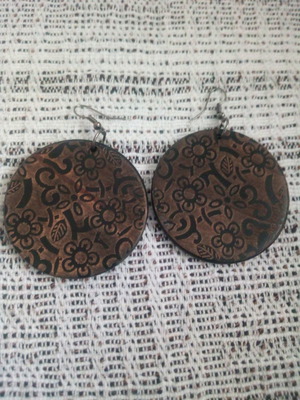 Alternative wooden hanging disc earrings used with carved design and pyrography