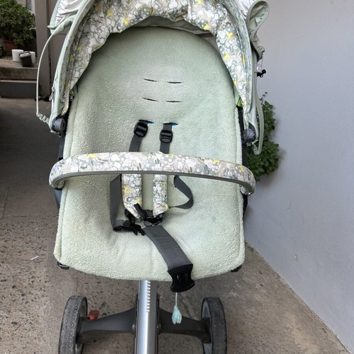 Stokke stroller used with two fabric sets, green and electric blue