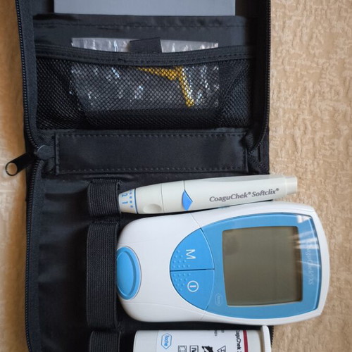 CoaguChek XS System INR meter used with original packaging and accessories