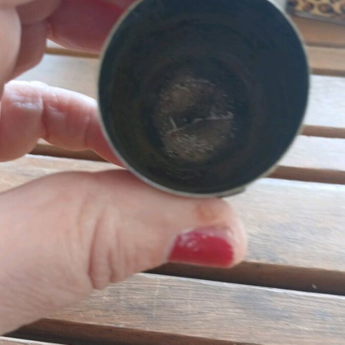 Silver shot glass used, with missing part on emblem
