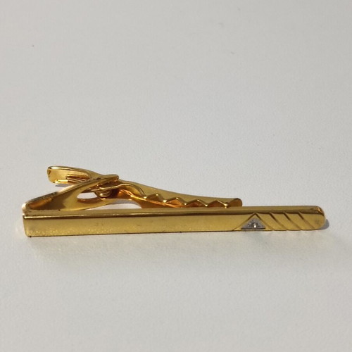 Tie clip used, gold color with silver accents