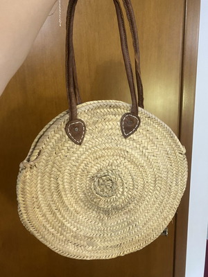 Round woven straw shoulder bag with leather handles