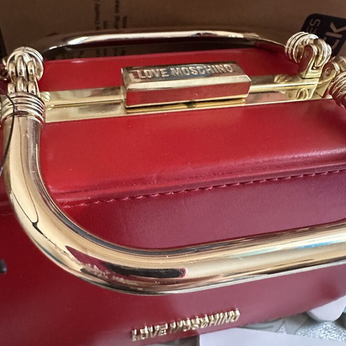 Love Moschino red shoulder bag like new with gold metal clasp and embossed detail
