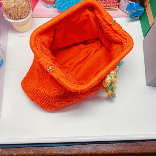 Handmade knitted clutch bag orange with metal frame