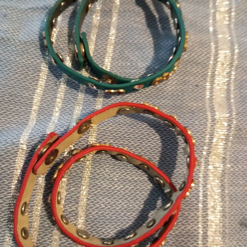 Leather bracelets used, red and green with charms