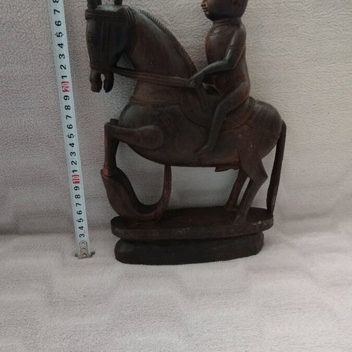 Wooden carving of South Indian man riding horse used