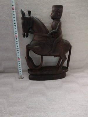 Wooden carving of South Indian man riding horse used