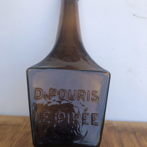 Antique glass bottle D.POURIS LE PIRÉE amber color