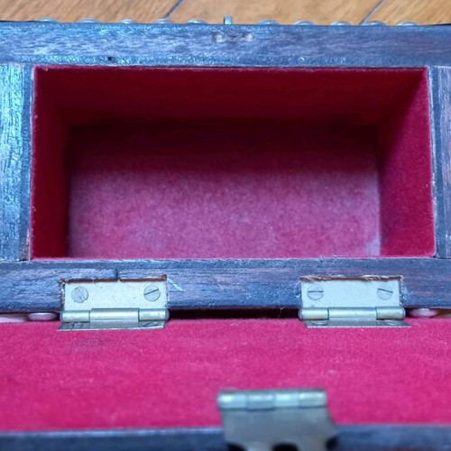 Decorative small wooden chest used with metal details
