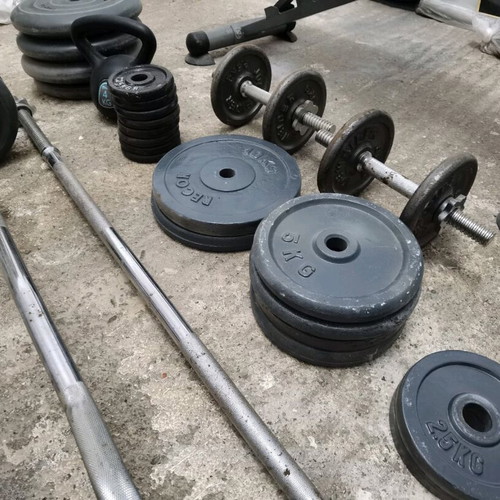 Gym equipment and weights used, set with Amila bench