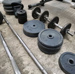 Gym equipment and weights used, set with Amila bench