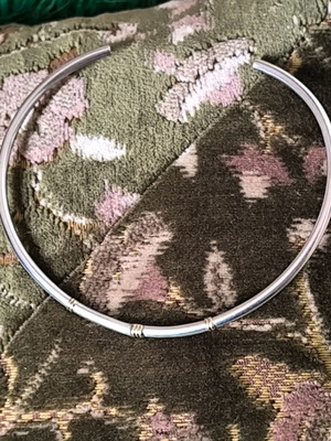 Silver neck rod like new with gold decorative details