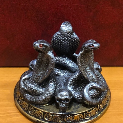 Decorative figurine with snakes and skulls