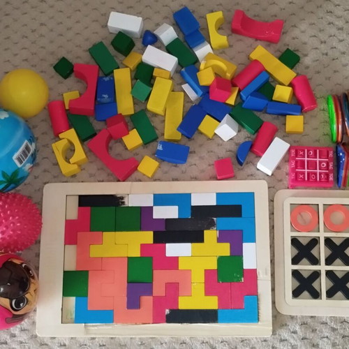 Wooden and magnetic toys used, including plastic mini tic-tac-toe and balls