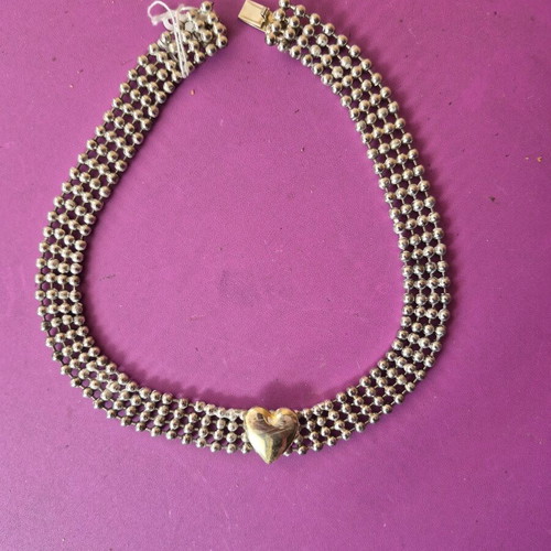 Silver choker necklace with gold-plated heart