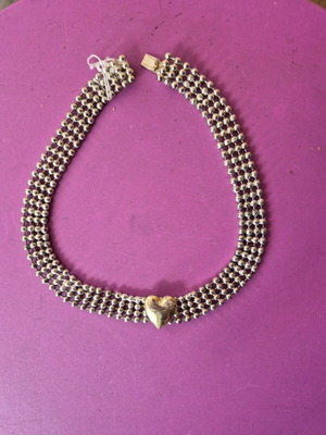 Silver choker necklace with gold-plated heart