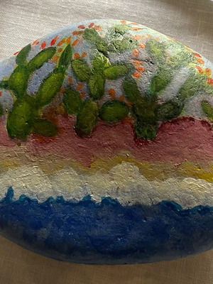 Large painted pebble with prickly pears on the seashore