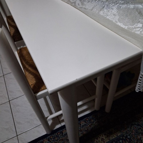 White wooden dining set used with 4 chairs with cane seats