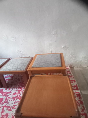Wooden side tables with plastic protection and decorative fabric