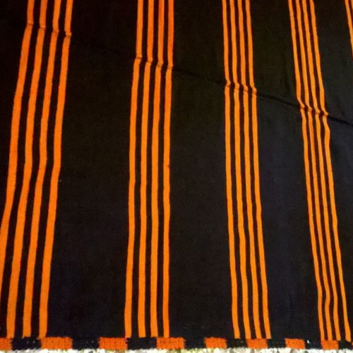 Woven blanket used orange and blue in two joined pieces