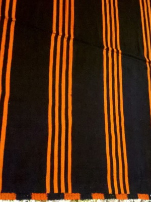 Woven blanket used orange and blue in two joined pieces