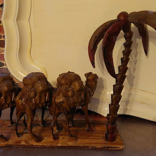 Decorative item used with camels and palm tree made of wood and plastic