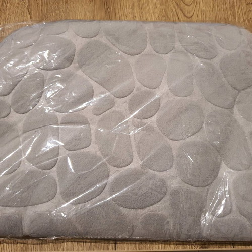 Bath mat unused in plastic wrap